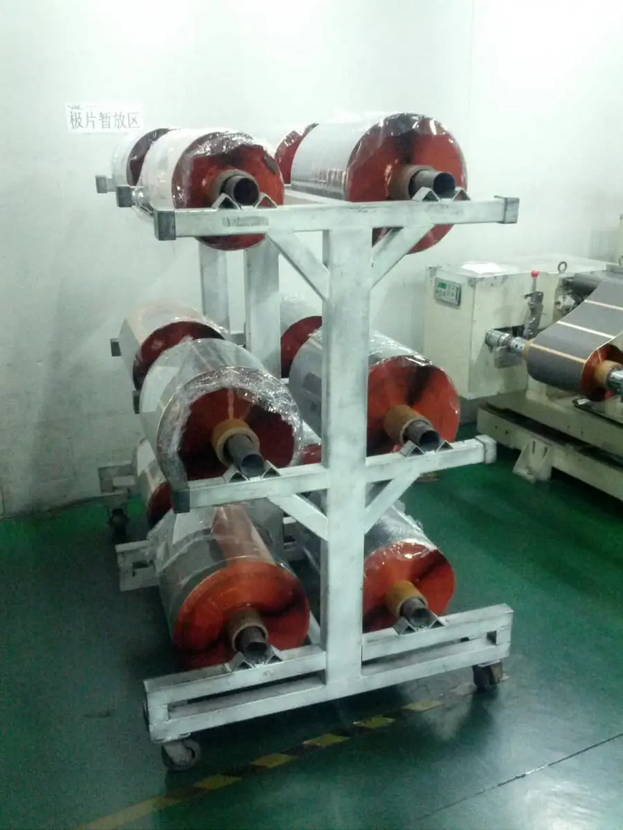 Raw electrode rolls ready for trimming.