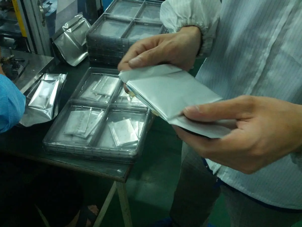 Electrode stacks in their housing, one side left open.